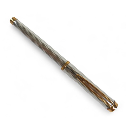 338 - A Waterman silver and gilt cartridge ink pen with an 18ct yellow gold nib 14cm long, with box.