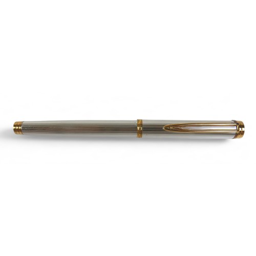 338 - A Waterman silver and gilt cartridge ink pen with an 18ct yellow gold nib 14cm long, with box.