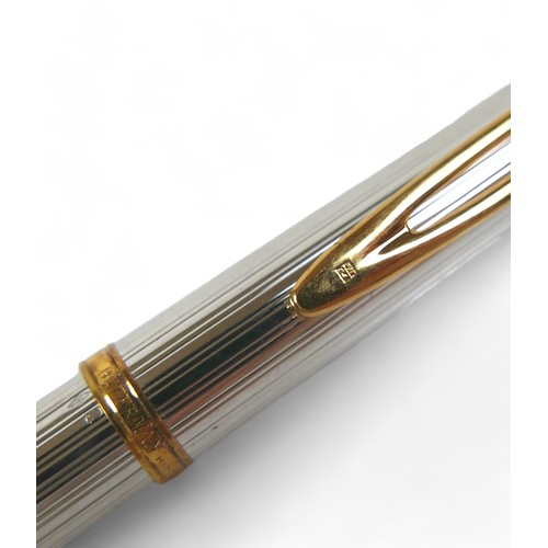 338 - A Waterman silver and gilt cartridge ink pen with an 18ct yellow gold nib 14cm long, with box.