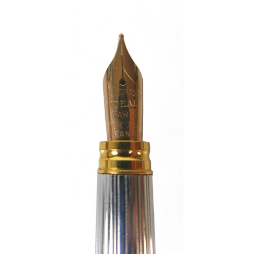 338 - A Waterman silver and gilt cartridge ink pen with an 18ct yellow gold nib 14cm long, with box.