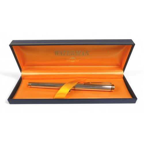 338 - A Waterman silver and gilt cartridge ink pen with an 18ct yellow gold nib 14cm long, with box.