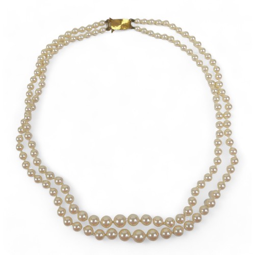 101 - A two-strand pearl necklace with 9ct gold clasp, a Heidi Kjeldsen red agate bead necklace (enhanced ... 