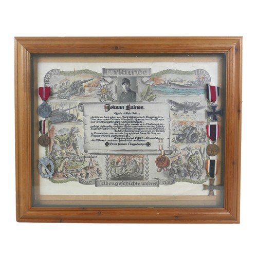 323 - A WWII German Third Reich remembrance poster, mounted with five German medals and a silver metal ass... 