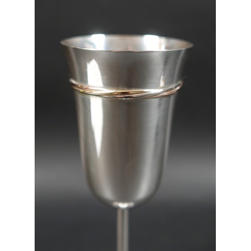 33 - A pair of Les Must de Cartier silver champagne flutes, circa 1990s, with gold, rose gold, and silver... 