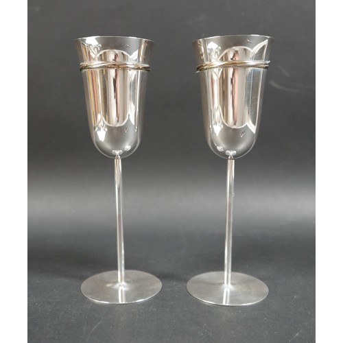 33 - A pair of Les Must de Cartier silver champagne flutes, circa 1990s, with gold, rose gold, and silver... 