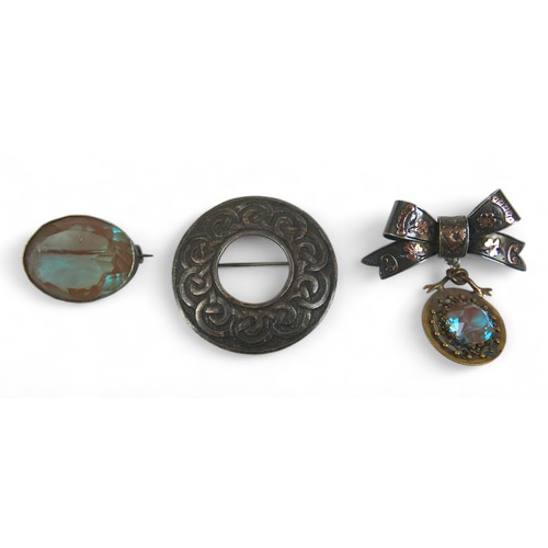 74 - Three pieces of jewellery, including a Victorian brooch set with a round cut saphiret, suspended fro... 