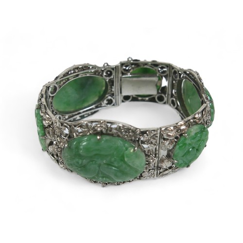 104 - A Chinese white metal and carved jade six panel bracelet, with push clasp, 19cm long when open.