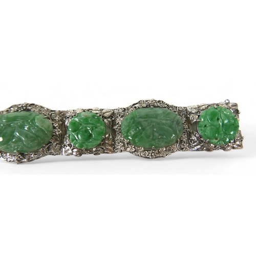 104 - A Chinese white metal and carved jade six panel bracelet, with push clasp, 19cm long when open.