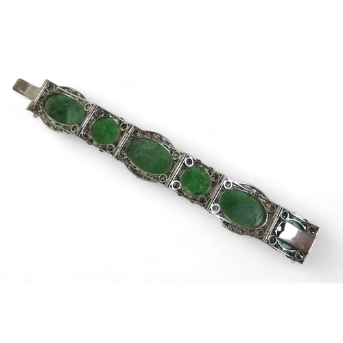 104 - A Chinese white metal and carved jade six panel bracelet, with push clasp, 19cm long when open.