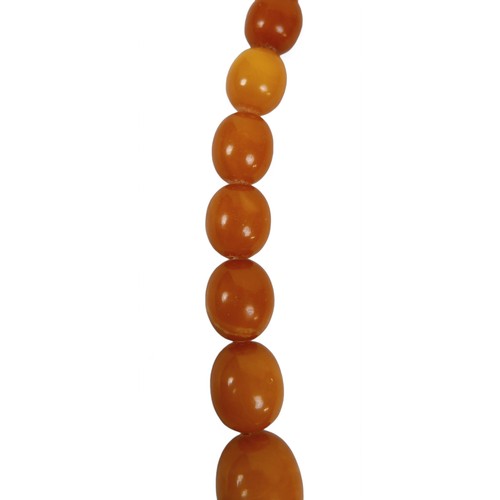 120 - A butterscotch amber bead necklace, with bolt ring clasp, of forty five graduating beads, largest be... 