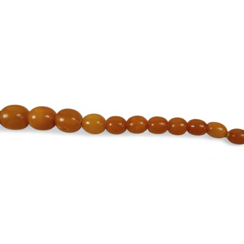 120 - A butterscotch amber bead necklace, with bolt ring clasp, of forty five graduating beads, largest be... 