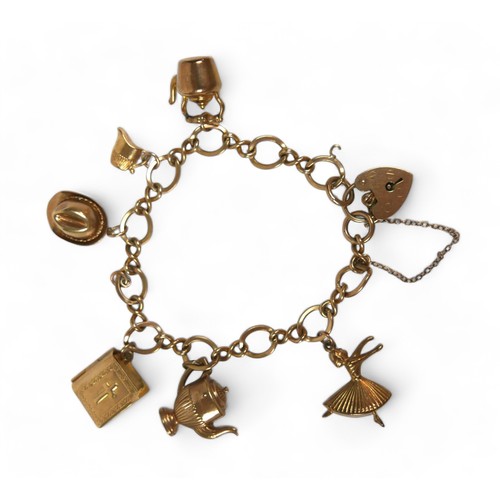 122 - A 9ct yellow gold charm bracelet, fitted with seven charms, 17.5g.