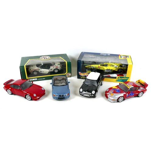 329 - A collection of six 1/18 scale model vehicles, comprising a boxed Corgi MGF, a boxed Mattel Hot Whee... 