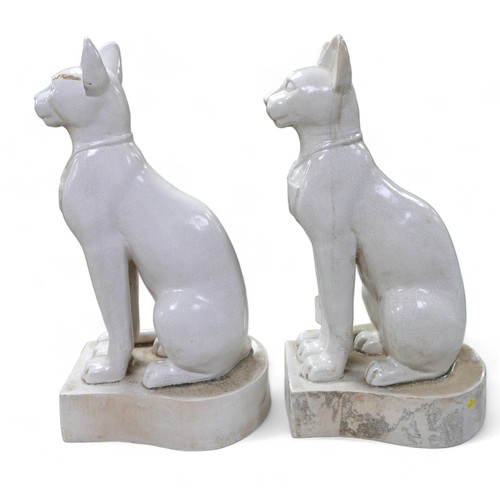 230 - A pair of large ceramic crackle glaze figures, each modelled as a seated Egyptian cat, 26 by 37 by 7... 