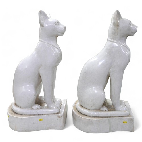 230 - A pair of large ceramic crackle glaze figures, each modelled as a seated Egyptian cat, 26 by 37 by 7... 