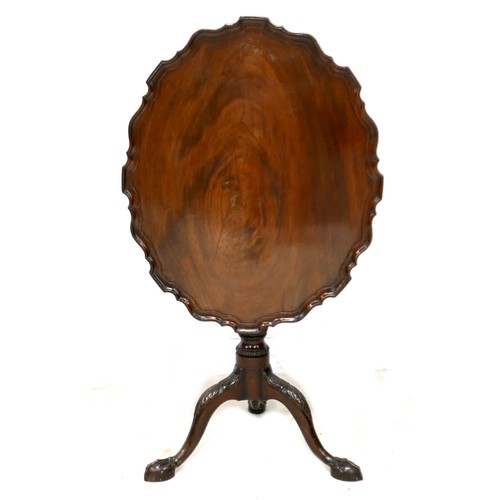 531 - A George III mahogany pie crust tilt top table, oval surface raised on a single column, cabriole leg... 