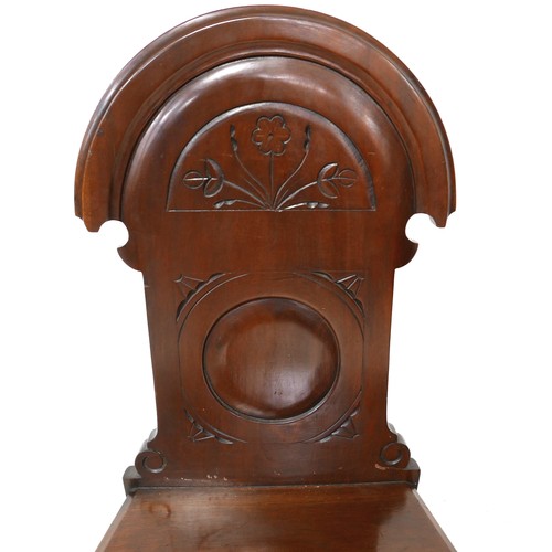 532 - A pair of Victorian mahogany hall chairs, with carved decoration to the shaped backs, each 43 by 40 ... 