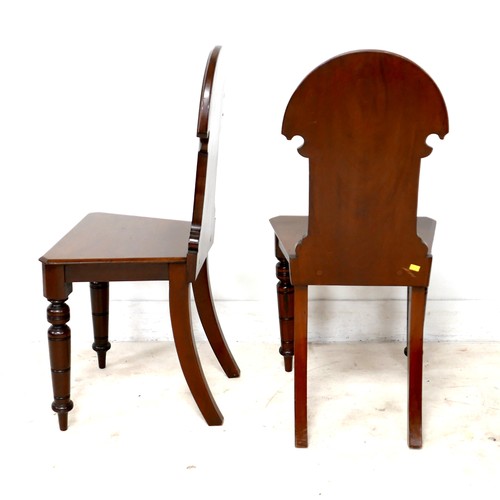 532 - A pair of Victorian mahogany hall chairs, with carved decoration to the shaped backs, each 43 by 40 ... 