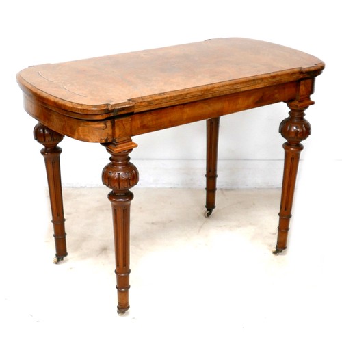 539 - A Victorian walnut fold over card table, with swivel top, inlaid decoration, raised on column suppor... 