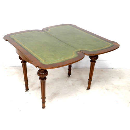 539 - A Victorian walnut fold over card table, with swivel top, inlaid decoration, raised on column suppor... 