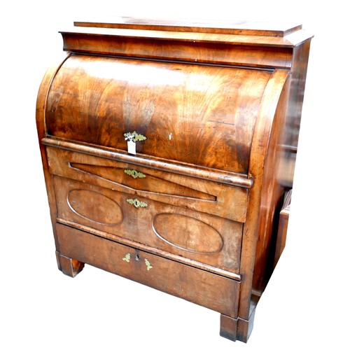 537 - A 19th century Continental walnut roll top bureau, with brushing slide over three drawers, raised on... 