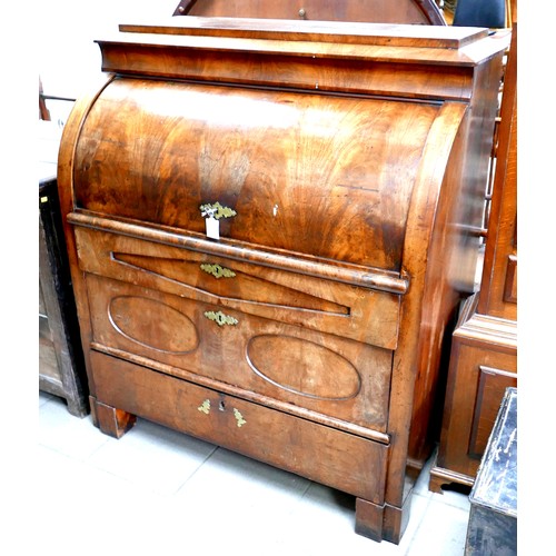 537 - A 19th century Continental walnut roll top bureau, with brushing slide over three drawers, raised on... 