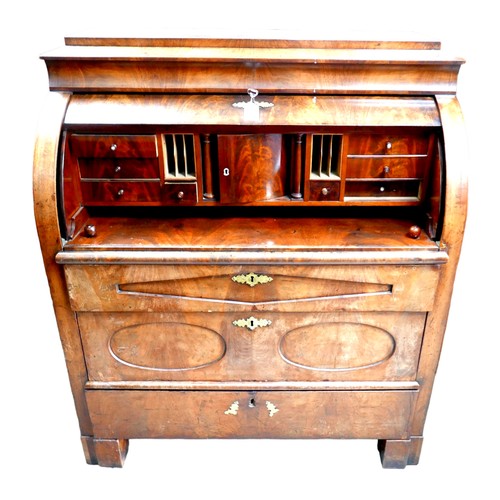 537 - A 19th century Continental walnut roll top bureau, with brushing slide over three drawers, raised on... 