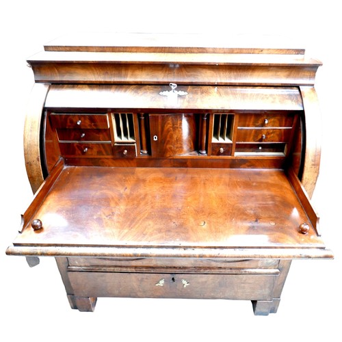 537 - A 19th century Continental walnut roll top bureau, with brushing slide over three drawers, raised on... 