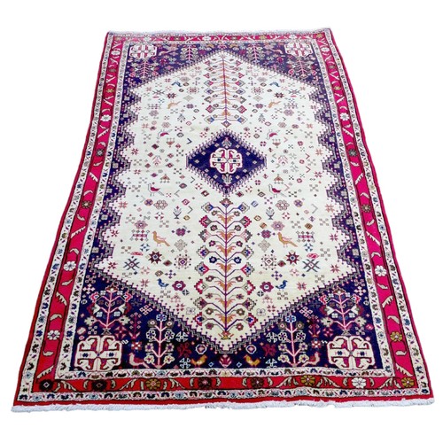 286 - A Shiraz rug, with cream ground, dark red and blue corners, 215 by 127cm.