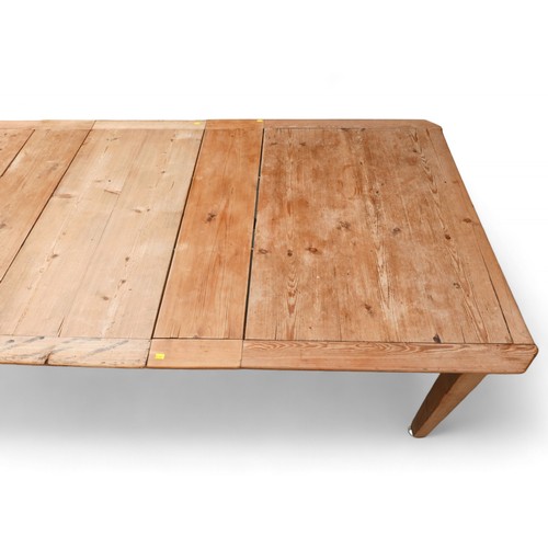 356 - A 19th century stripped pine wind out kitchen table with three leaves, extends from 131 to 217cm, 10... 