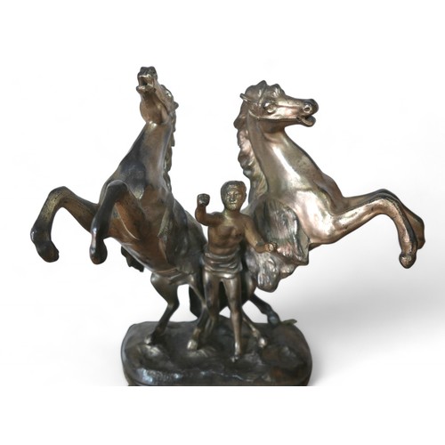 174 - A late Victorian spelter mantel clock, with a black marble base surmounted by Marly type horse group... 