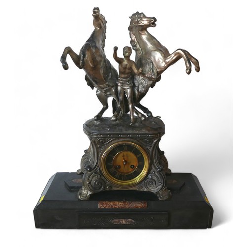 174 - A late Victorian spelter mantel clock, with a black marble base surmounted by Marly type horse group... 