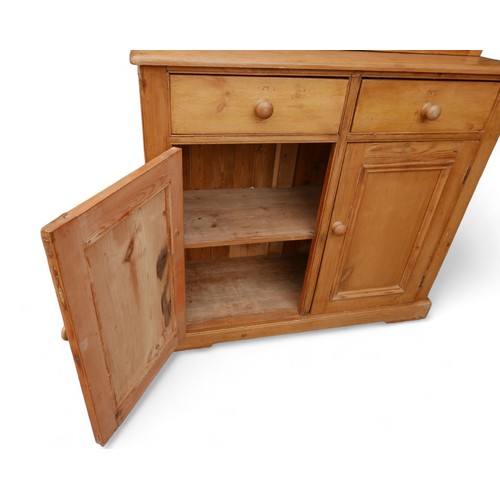 354 - A stripped pine kitchen dresser, with a two door glazed top over a two drawer two door base, 119 by ... 