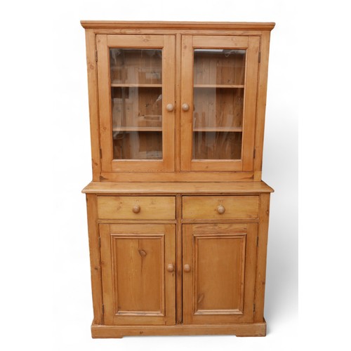 354 - A stripped pine kitchen dresser, with a two door glazed top over a two drawer two door base, 119 by ... 