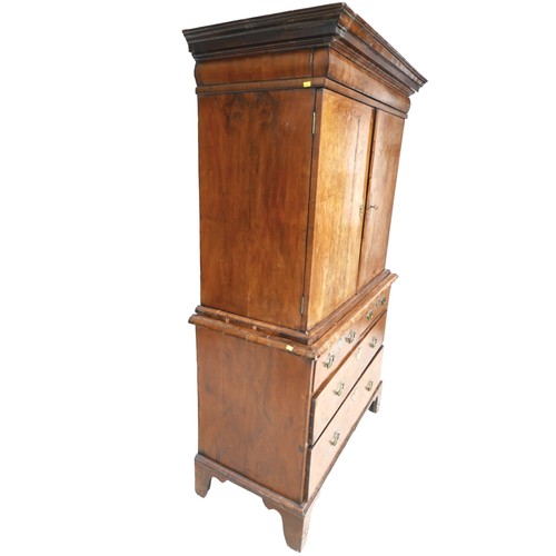 365 - A George I / George II walnut cabinet on chest, with a cushion drawer above two doors enclosing a fi... 