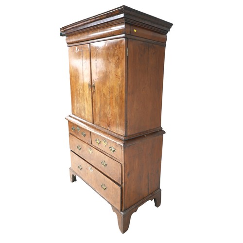 365 - A George I / George II walnut cabinet on chest, with a cushion drawer above two doors enclosing a fi... 