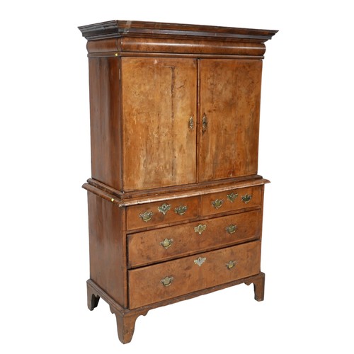 365 - A George I / George II walnut cabinet on chest, with a cushion drawer above two doors enclosing a fi... 