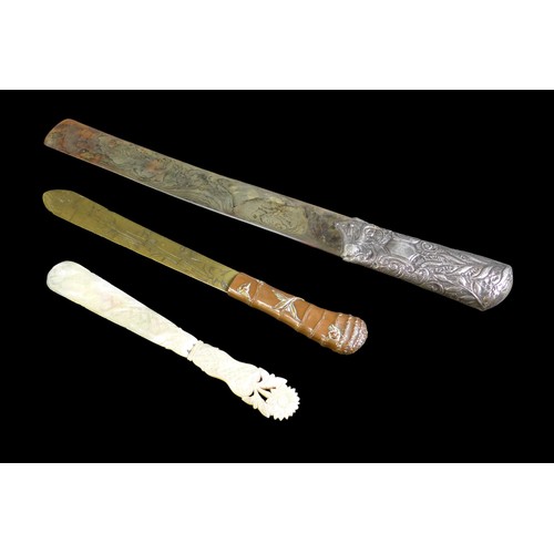 143 - Three 19th century page turners, comprising a Japanese brass and copper turner, 29cm long, a silver ... 