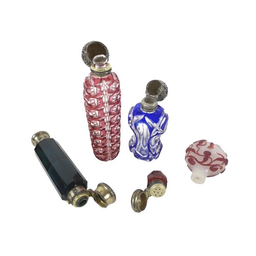 132 - Three 19th century glass perfume bottles, one double ended in dark blue, 12.5cm long, two flashed gl... 