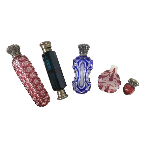 132 - Three 19th century glass perfume bottles, one double ended in dark blue, 12.5cm long, two flashed gl... 