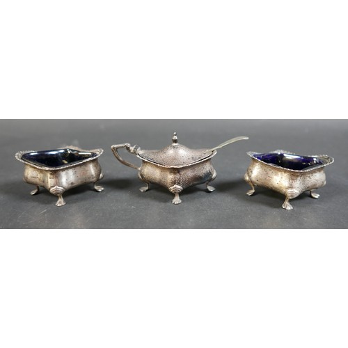 21 - A silver four piece cruet, pepperette 8cm high, and three silver mustard spoons, largest 11cm long, ... 