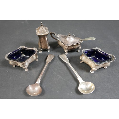 21 - A silver four piece cruet, pepperette 8cm high, and three silver mustard spoons, largest 11cm long, ... 