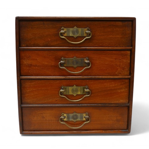 190 - A polished walnut desk top 'Popular' cabinet by Stone's, with a bank of four drawers with brass hand... 