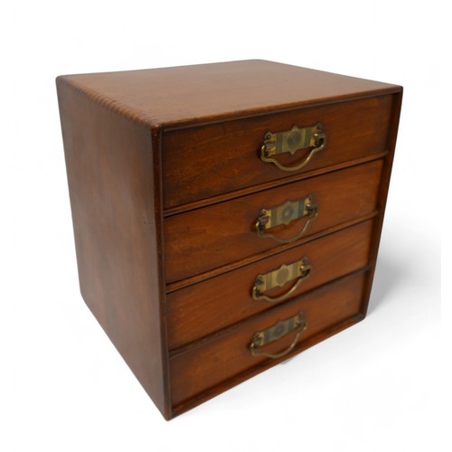 190 - A polished walnut desk top 'Popular' cabinet by Stone's, with a bank of four drawers with brass hand... 