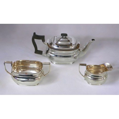 6 - A George V three-piece silver tea set, comprising teapot, 28 by 12 by 13cm high, twin handled sugar ... 