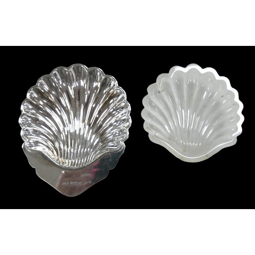 20 - A group of 20th century silver, comprising an ERII shell form butter dish, 10 by 8.5 by 2cm high, wi... 