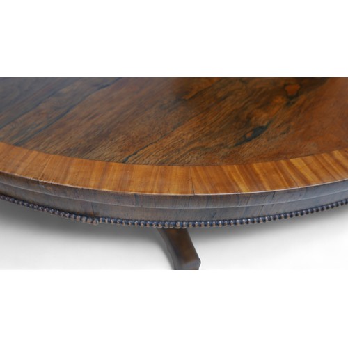 355 - A Regency cross banded rosewood tilt top breakfast table, on a tapering triangular column and platfo... 