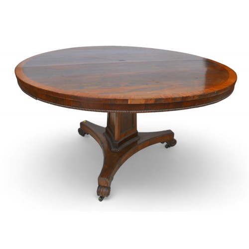 355 - A Regency cross banded rosewood tilt top breakfast table, on a tapering triangular column and platfo... 