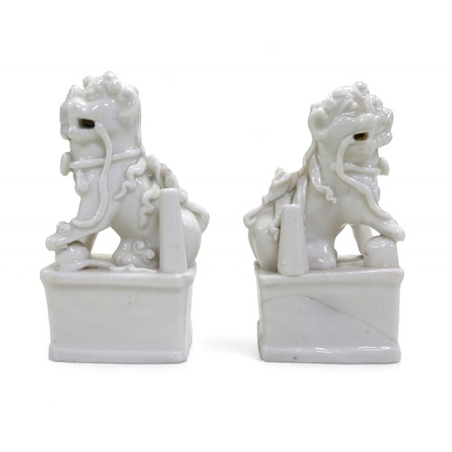 105 - A pair of Chinese blanc de chine Fo dogs, 7 by 5 by 13cm high.