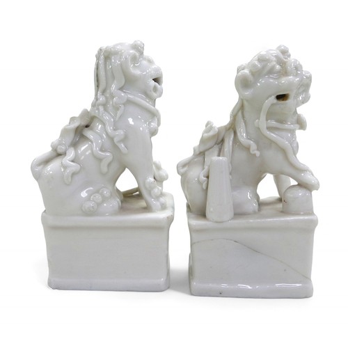 105 - A pair of Chinese blanc de chine Fo dogs, 7 by 5 by 13cm high.